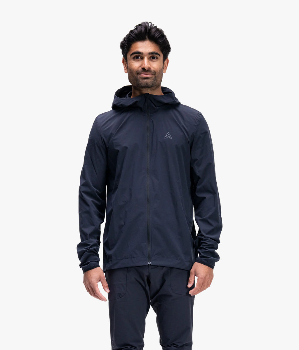 Man wearing a dark blue raincoat on a white background