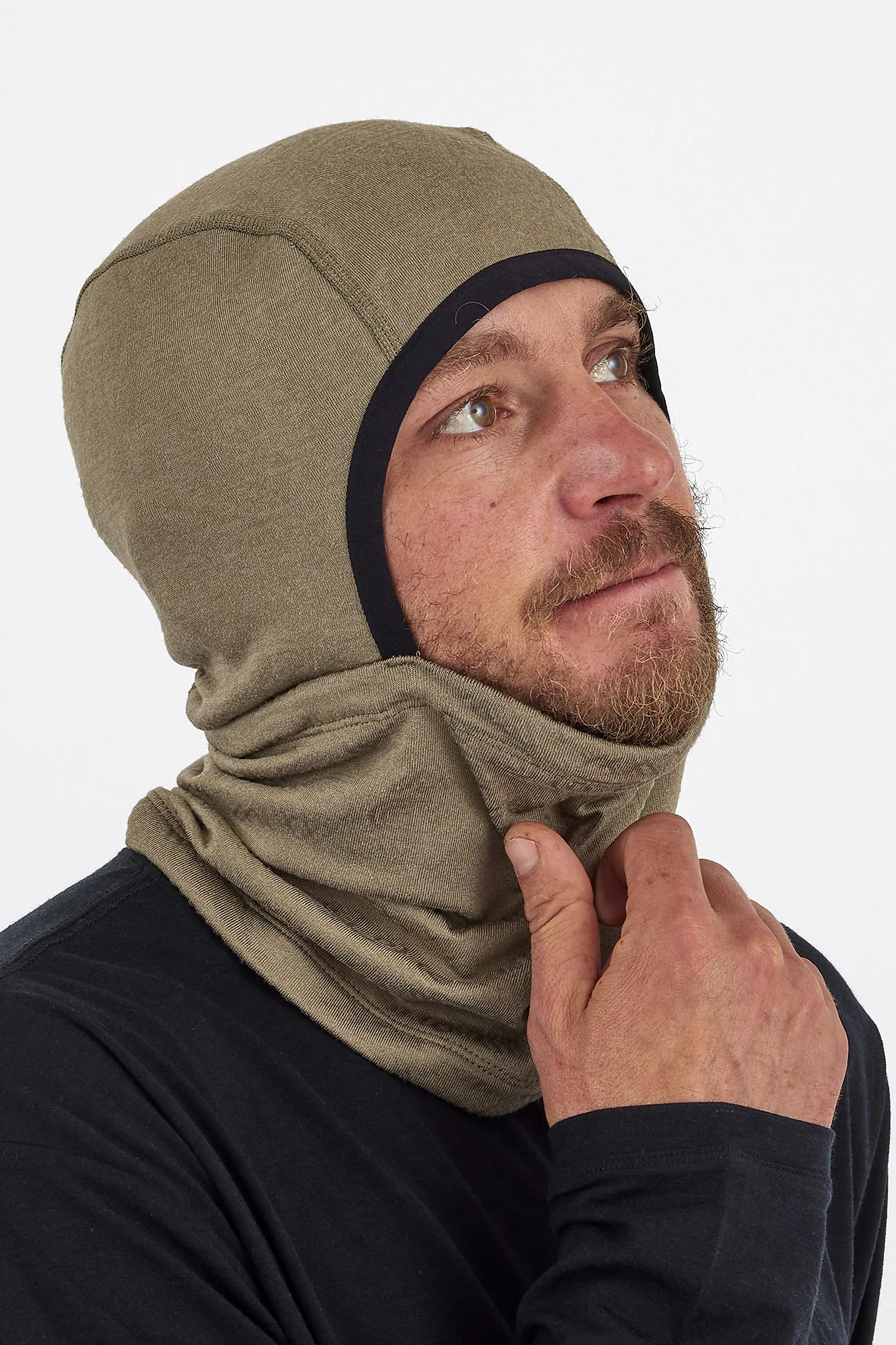 Person wearing a beige balaclava against a white background
