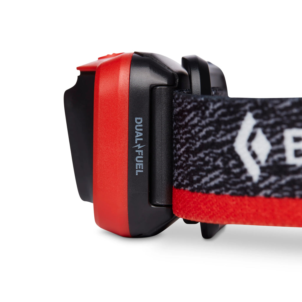 Red and black dual-fuel headlamp on a white background