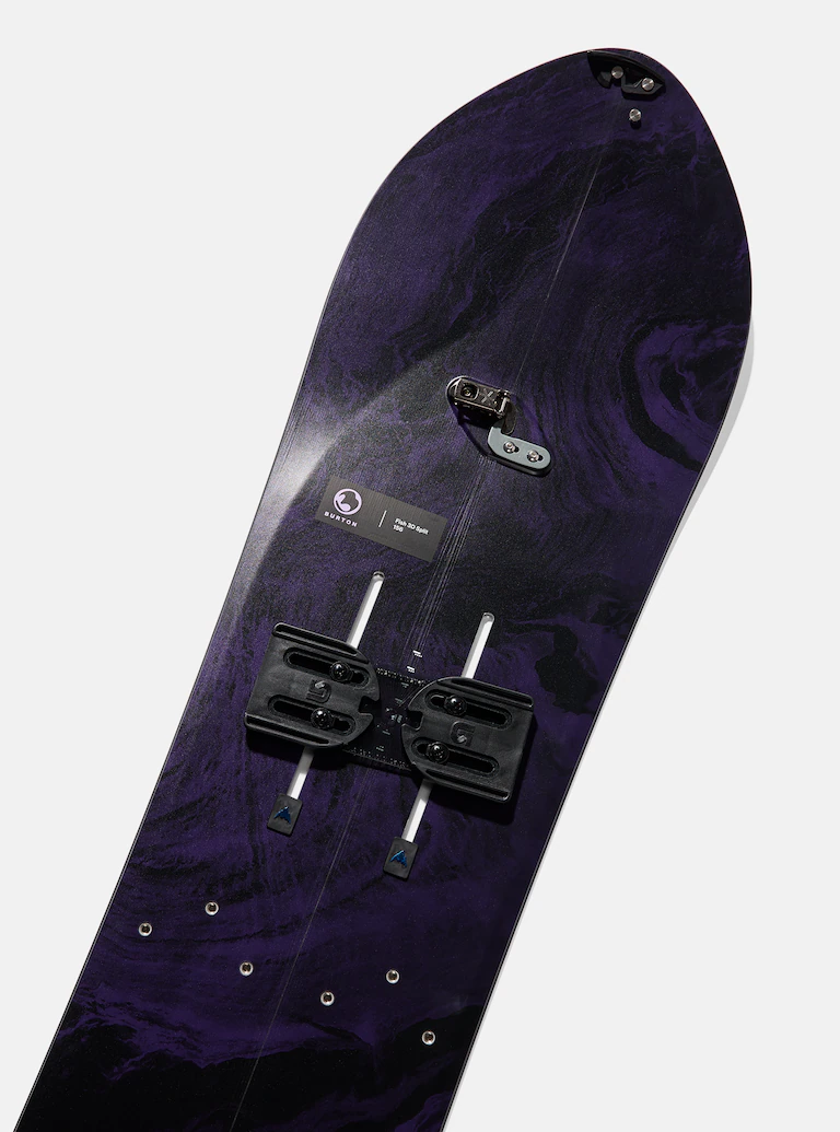 Purple snowboard with bindings on a white background