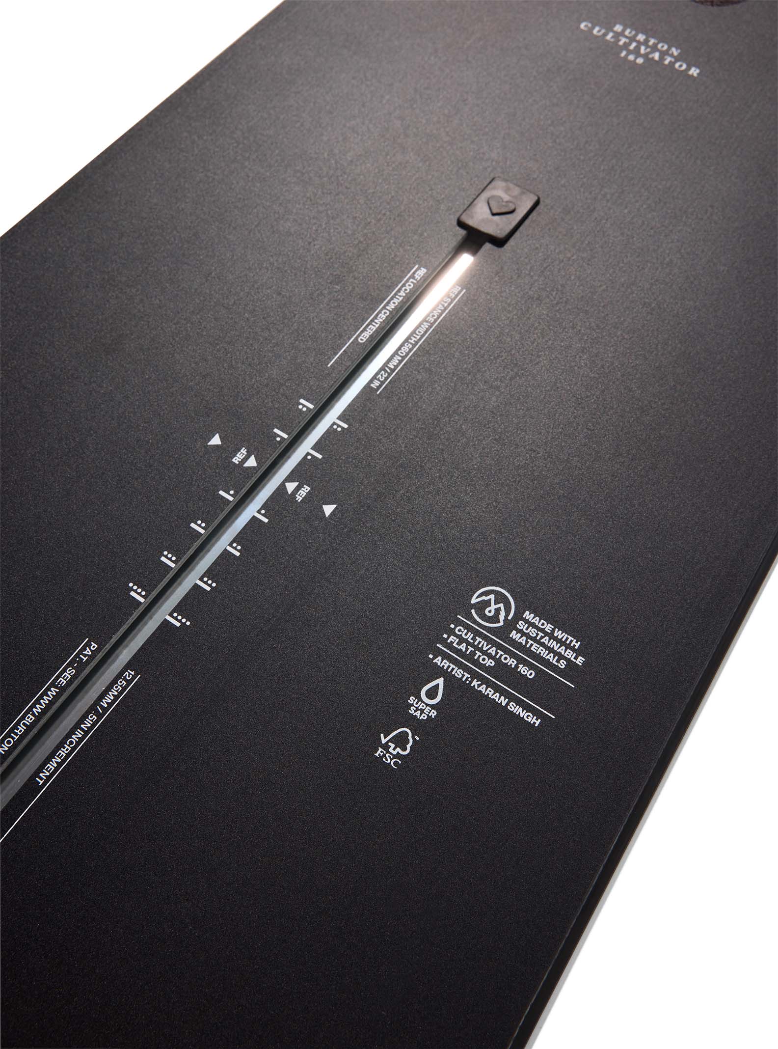 Black snowboard with branding and specifications on a white background
