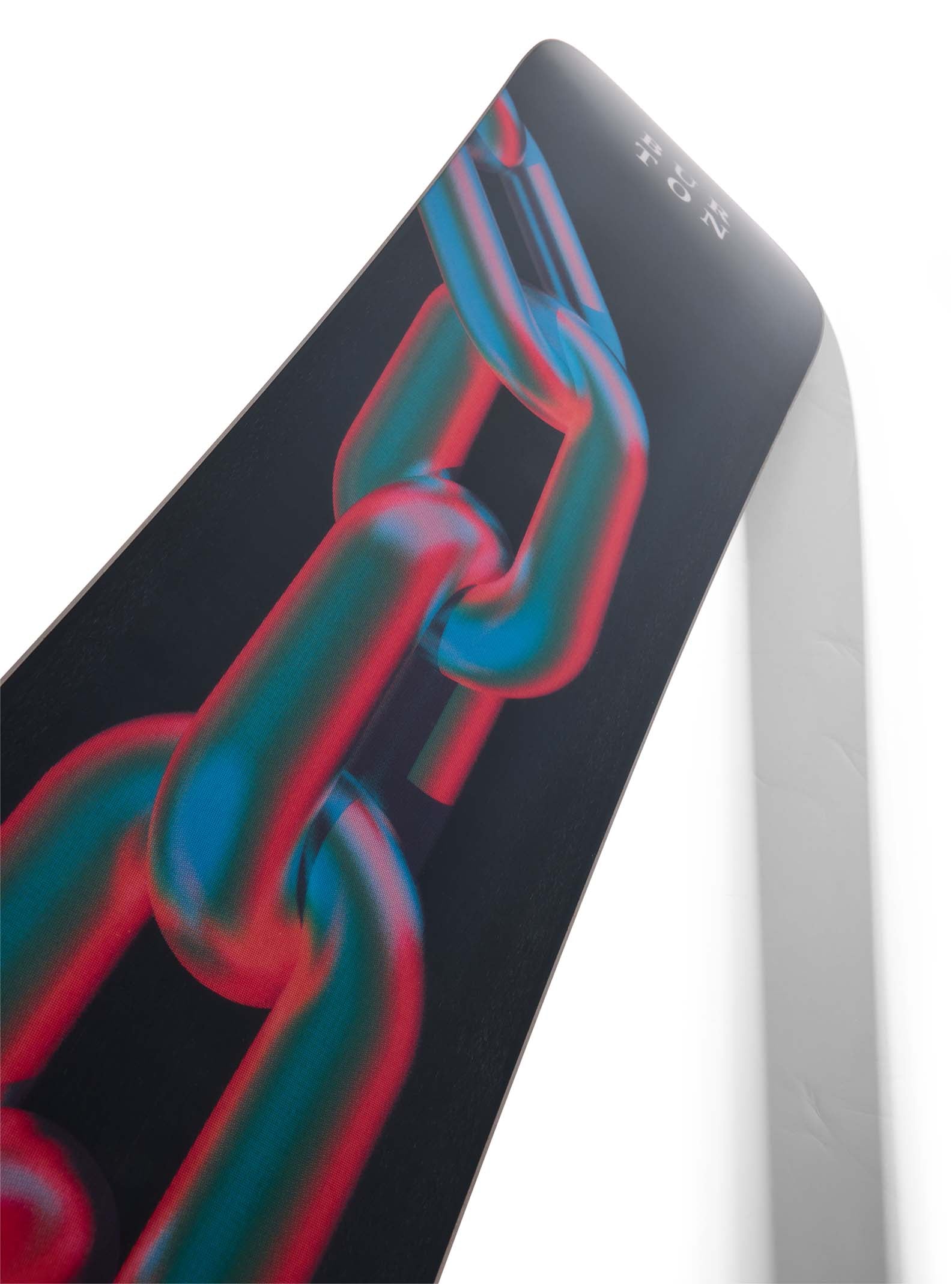 Close-up of a snowboard with a chain design on the bottom