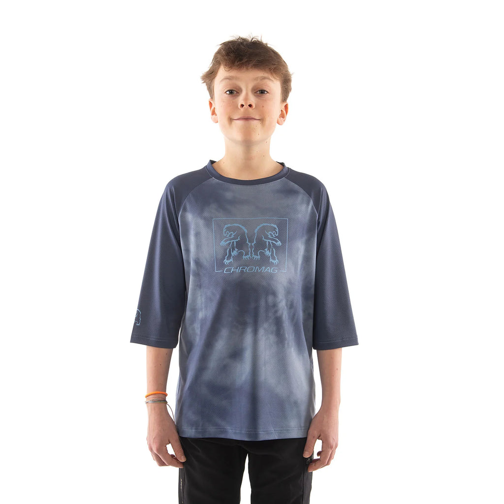 Child wearing a blue tie-dye shirt with a logo on a white background