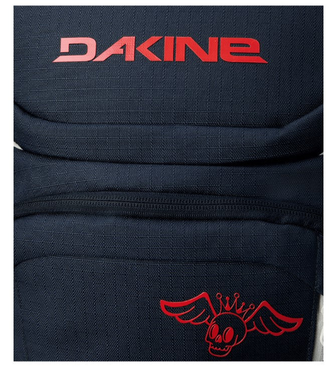 Black backpack with red Dakine logo and skull design on a white background