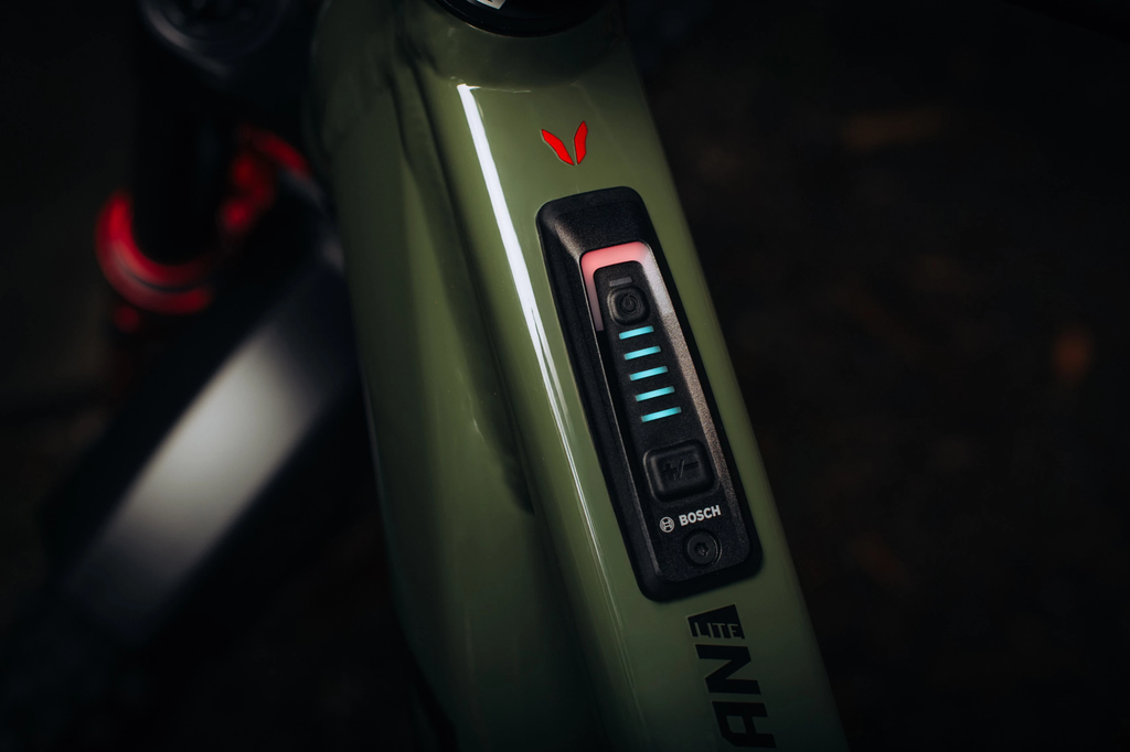 Close-up of a green electronic device with a brand logo on a dark background