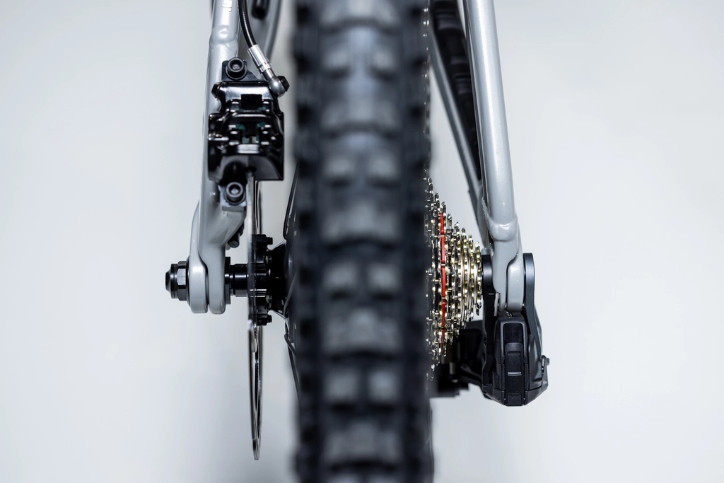 Close-up of a bicycle's rear wheel and gear system on a white background
