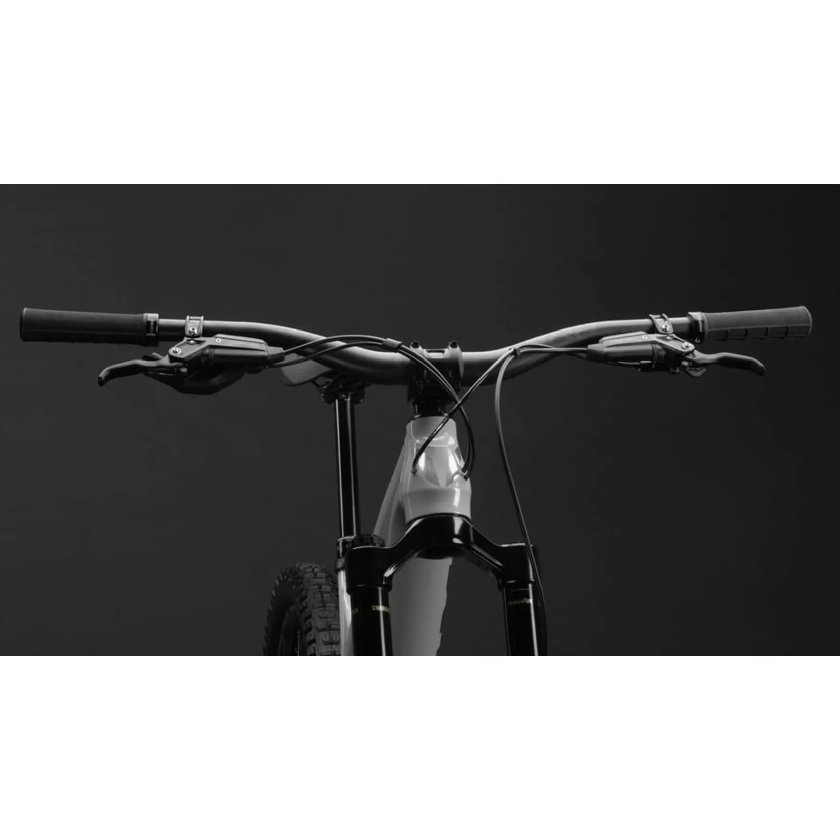 Close-up of a bicycle handlebar with a black background