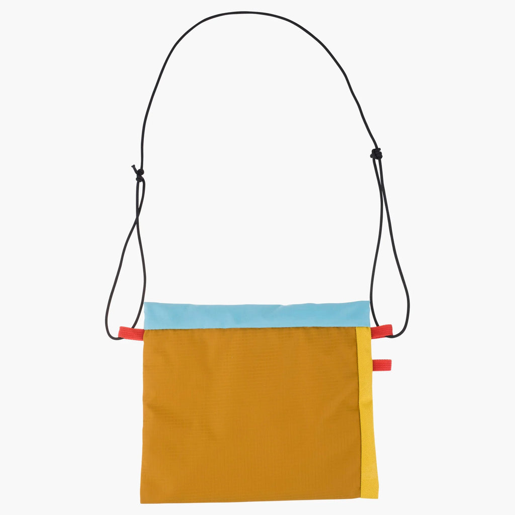A colorful crossbody bag with a mustard yellow body, a light blue horizontal stripe, a yellow vertical stripe, and a black adjustable shoulder strap, shown against a plain white background.