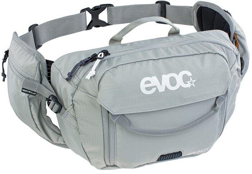 A light gray Evoc waist pack with multiple zippered pockets, a top carry handle, and an adjustable waist strap, shown on a plain white background.