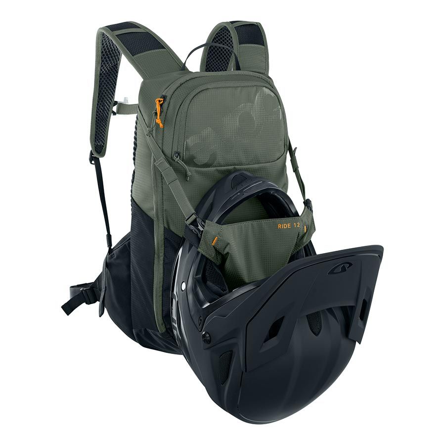 Green backpack with a helmet inside on a white background