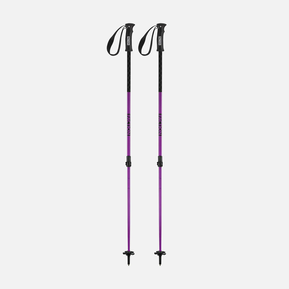Two purple and black ski poles on a light gray background