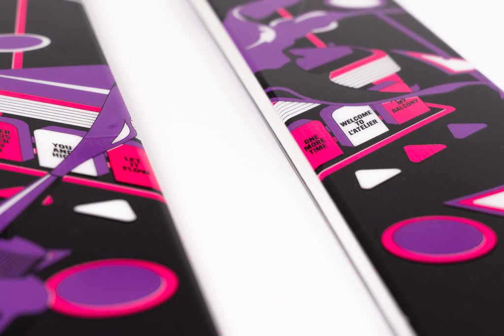 Close-up of a pair of skis with a stylized cover design on a white background