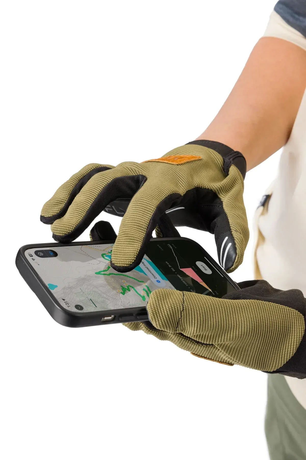 Person wearing green gloves holding a smartphone with a white background