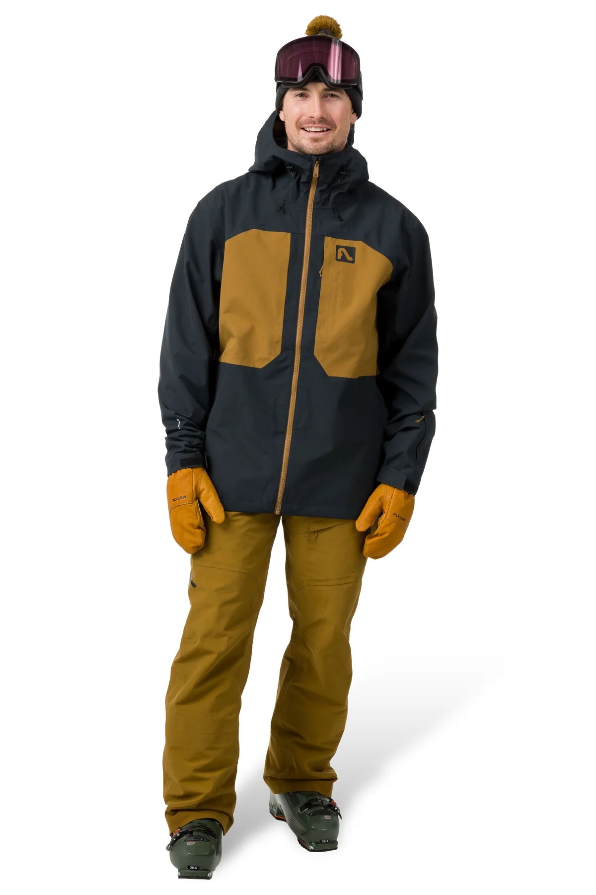 Person wearing a black and brown jacket with matching pants on a white background