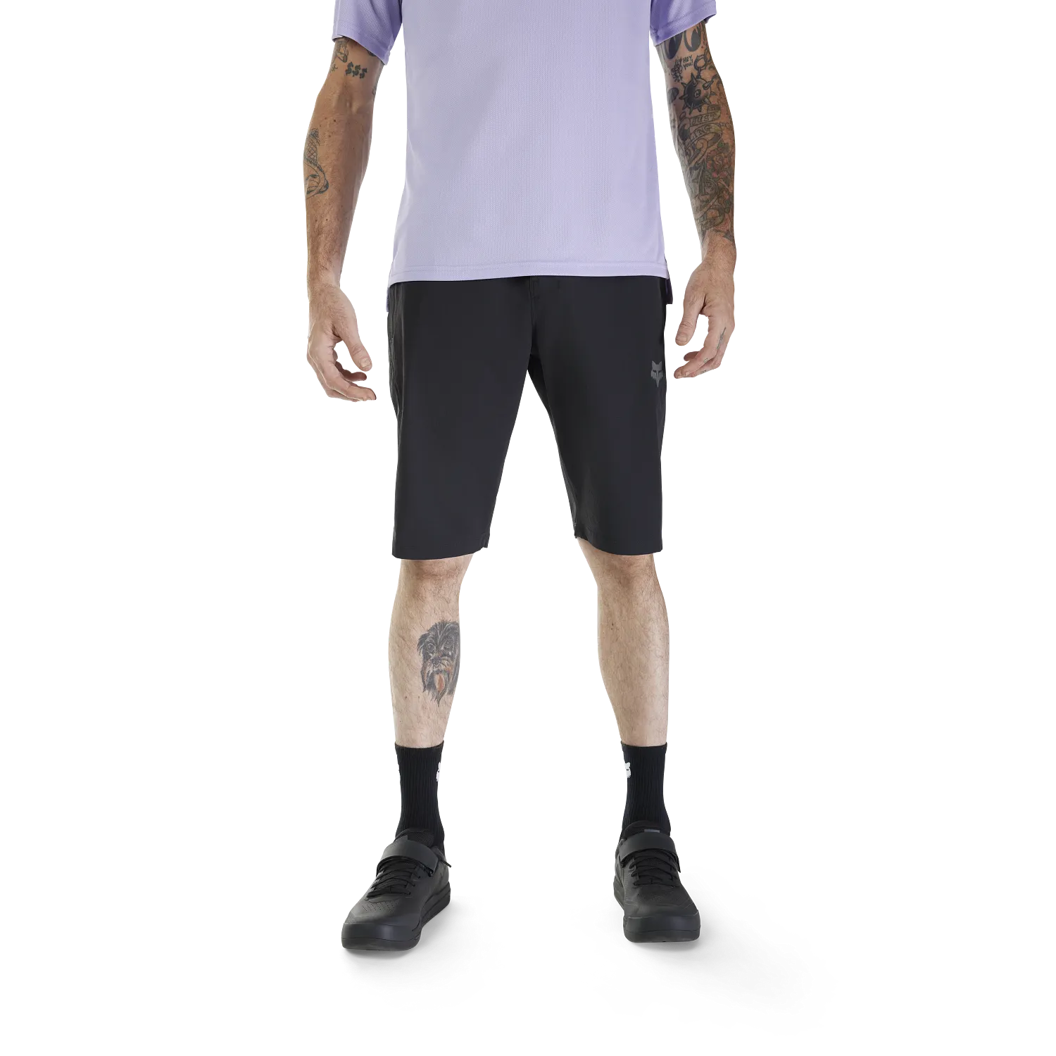 Person wearing black shorts and a light purple shirt on a white background