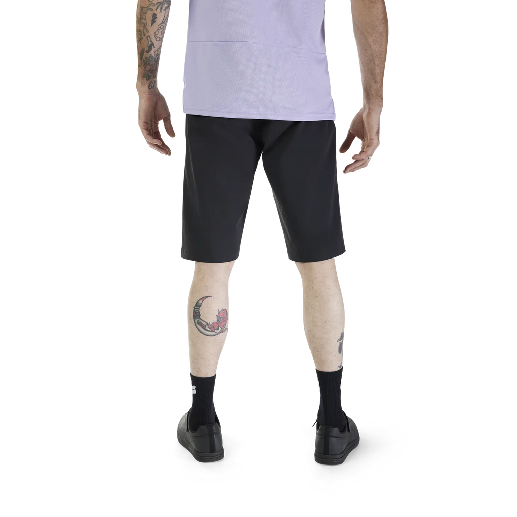 Person wearing black shorts on a white background