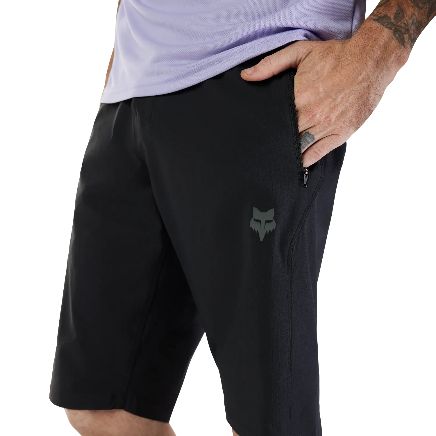 Person wearing black shorts with a logo on a white background