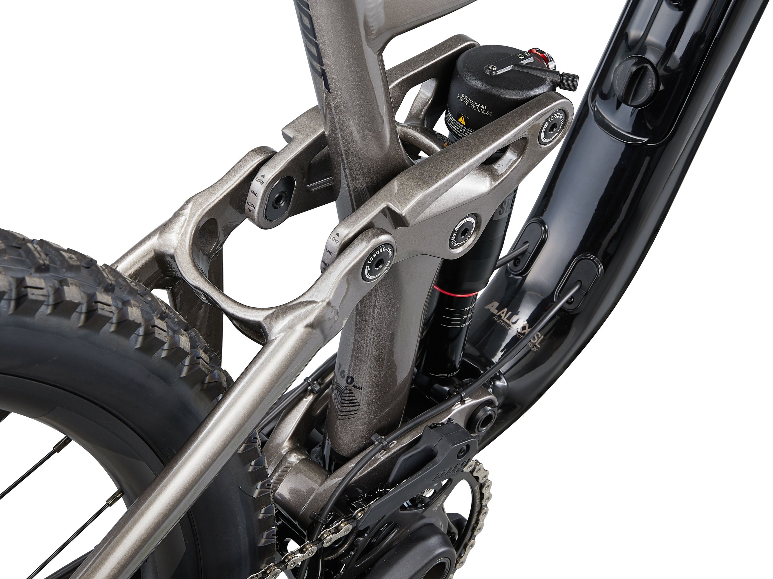 Close-up of a bicycle's suspension fork and chain on a white background
