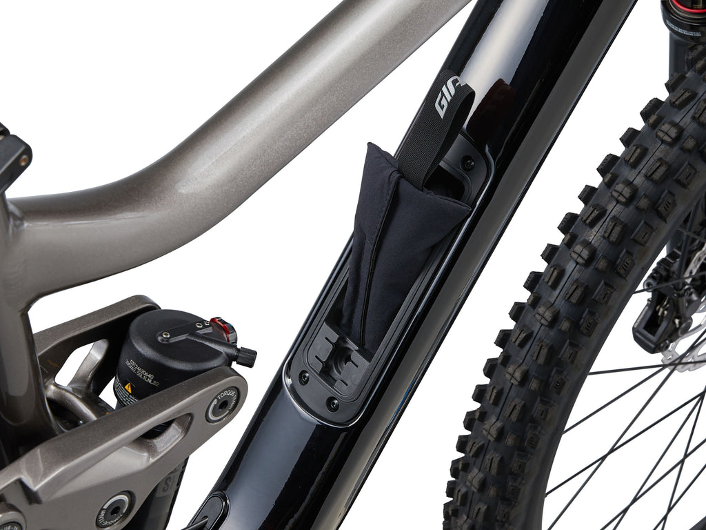 Close-up of a bicycle's suspension fork and chainstay on a white background