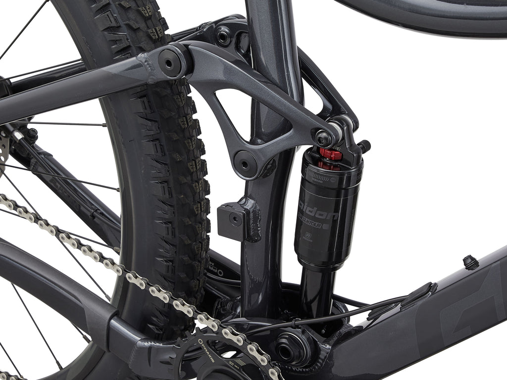 Close-up of a bicycle suspension fork and chain on a white background