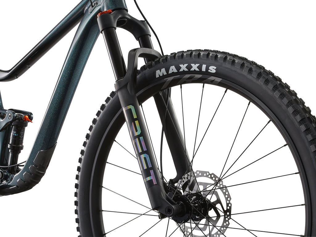Close-up of a bicycle wheel with Maxxis tire and Coeur suspension fork on a white background
