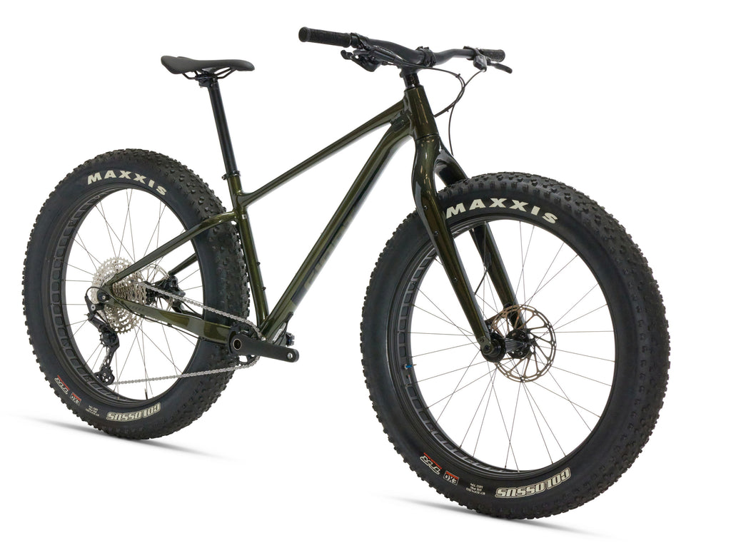 Green mountain bike with Maxxis tires on a white background