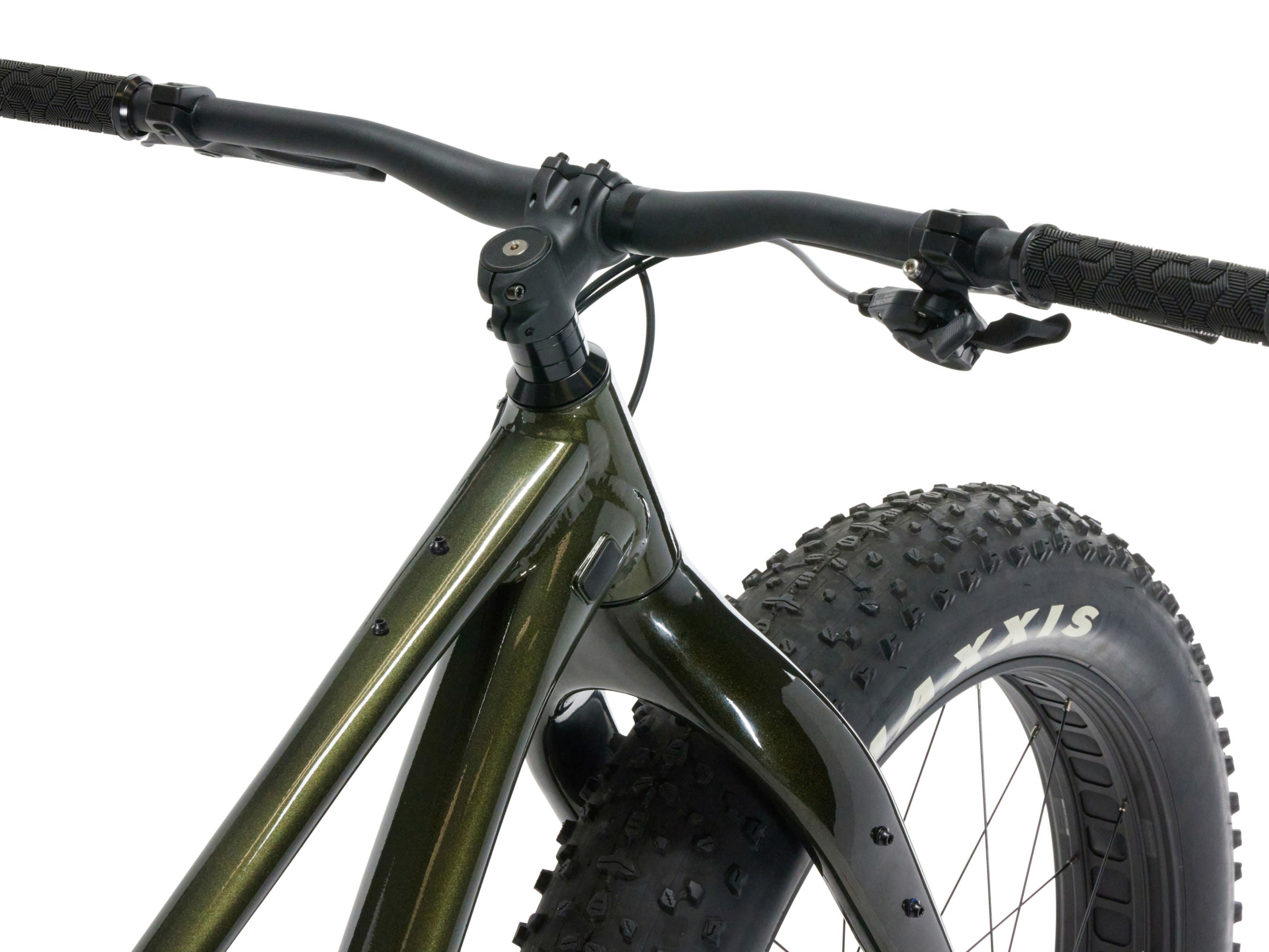 Close-up of a green fatbike with knobby tires on a white background
