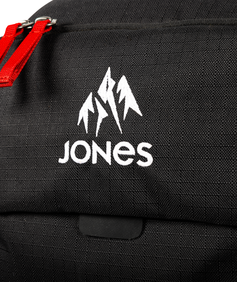 Black bag with a red zipper and white 'JONES' logo on a black background