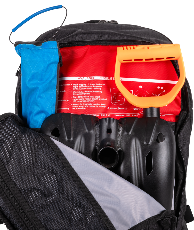 Backpack with avalanche rescue tools including a blue probe, red shovel, and black backpack.