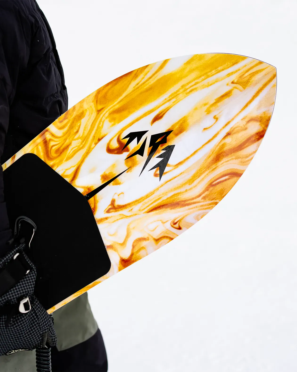 Person holding a yellow and orange surfboard with a black logo on a white background