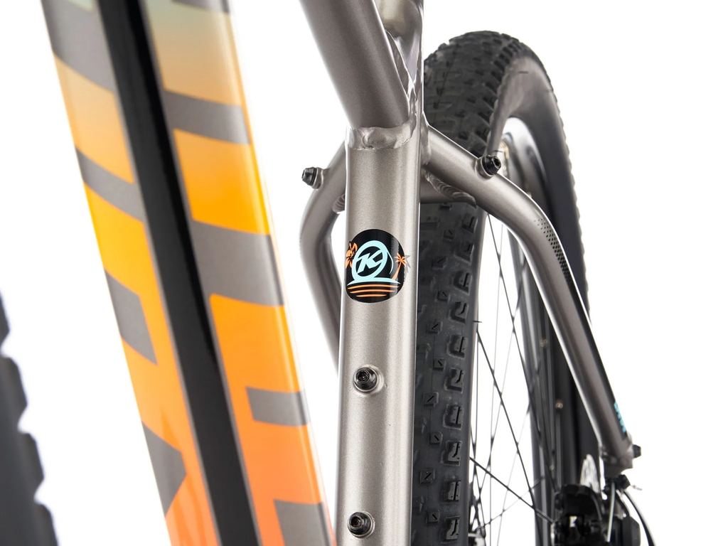 Close-up of a bicycle with an orange frame and black tires on a white background