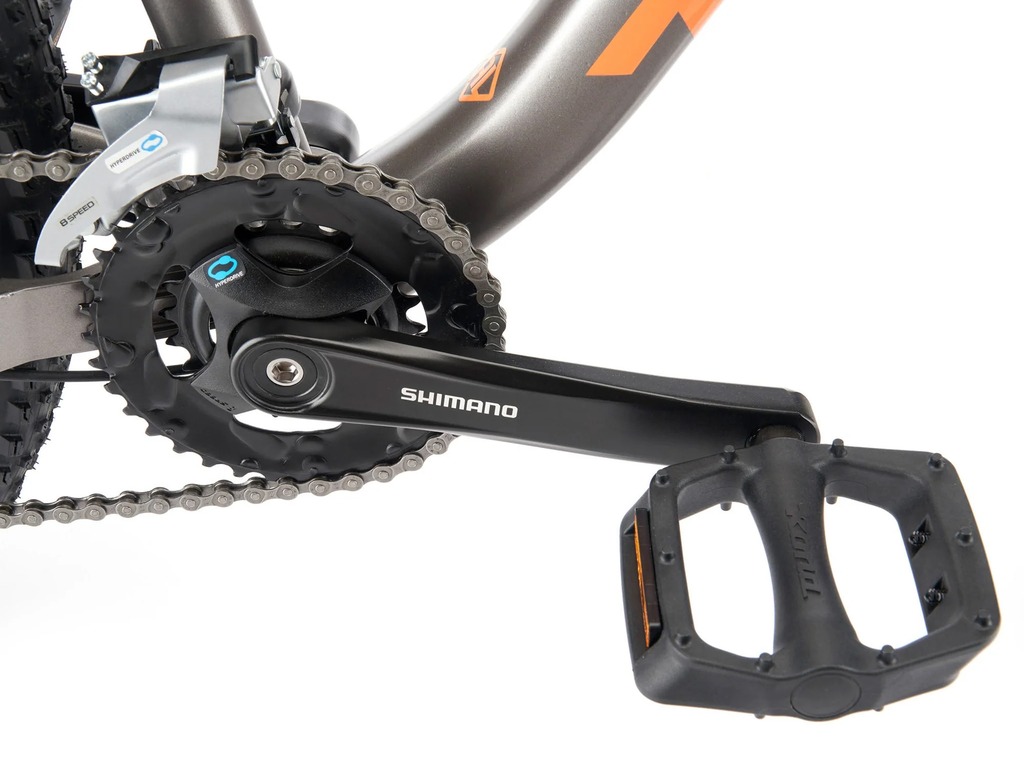 Close-up of a Shimano bicycle pedal and chain mechanism on a white background