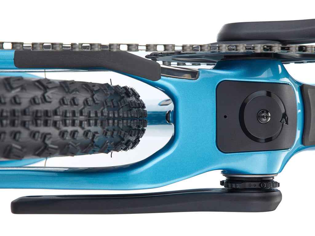 Close-up of a blue bicycle with a black tire tread pattern on a white background