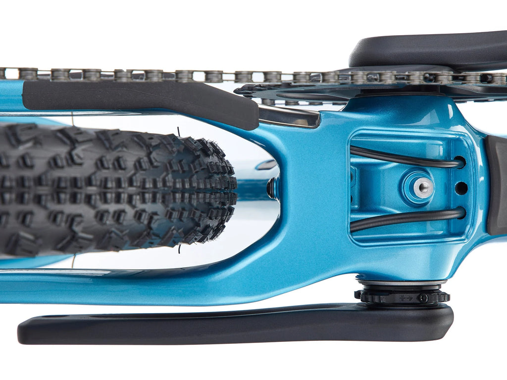 Close-up of a blue bicycle with black tire tread on a white background