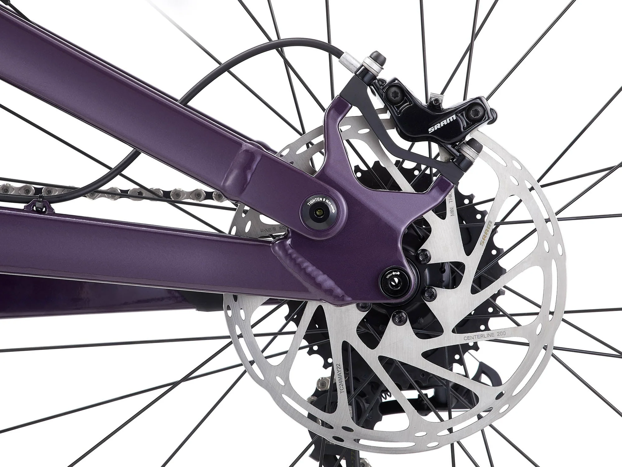 Close-up of a bicycle's purple frame and disc brake system.