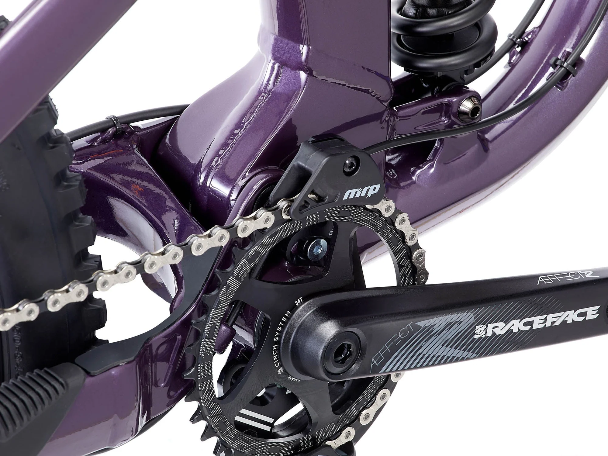 Close-up of a bicycle chain and gear system with 'RaceFace' branding on a white background