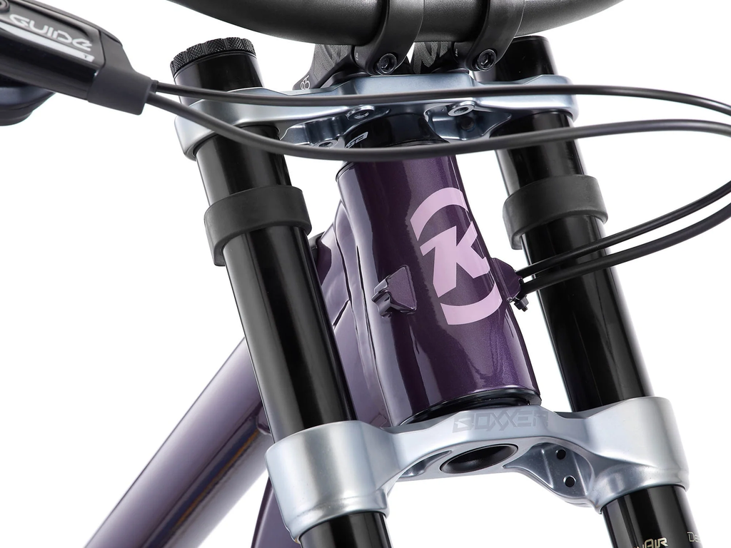 Close-up of a bicycle suspension fork with a brand logo on a white background
