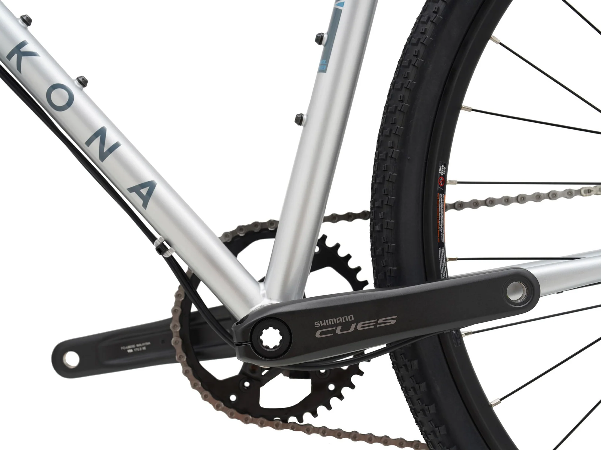 Close-up of a bicycle chain and gear system with 'Kona' branding on a white background