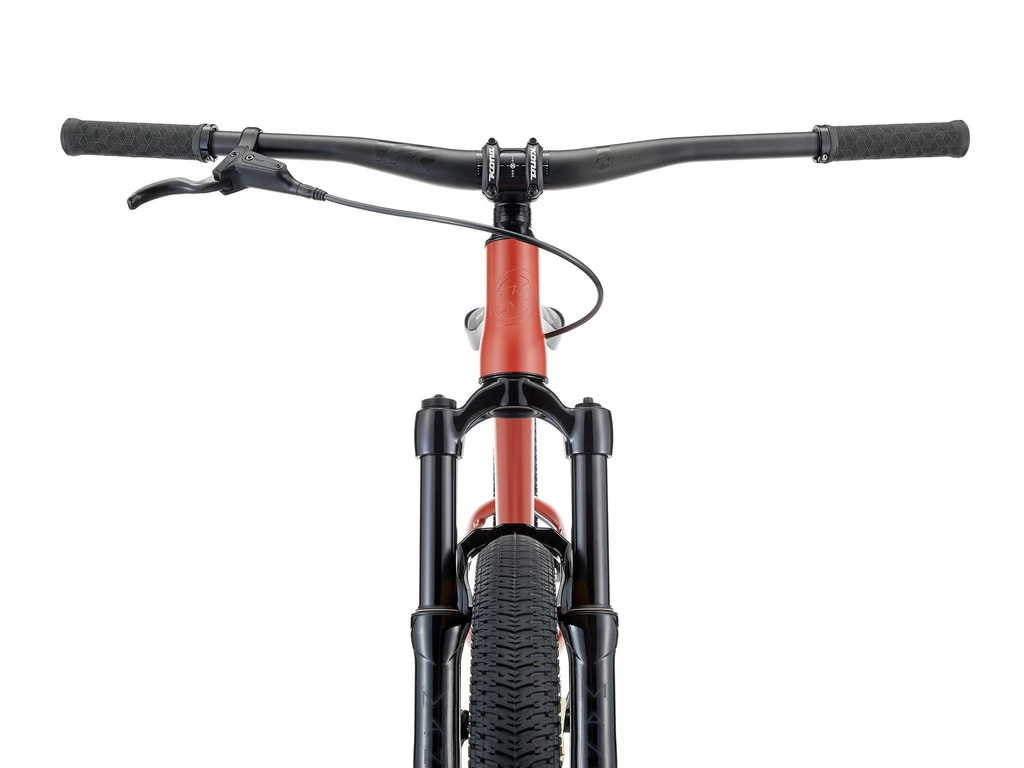 Close-up of a bicycle handlebar and front wheel on a white background
