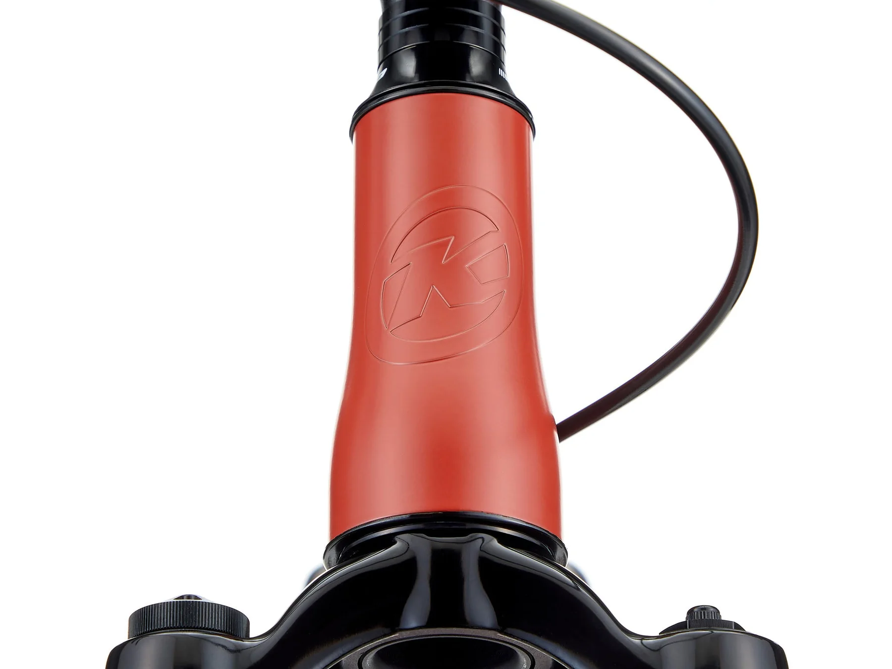 Close-up of a red bicycle hub with a black cable on a white background