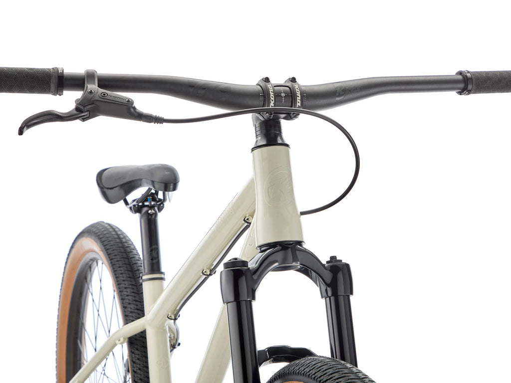 Close-up of a bicycle handlebar and front wheel on a white background