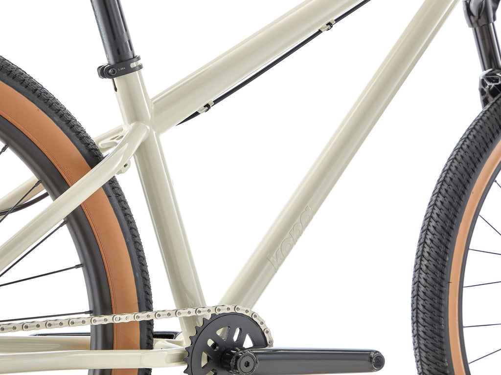 Close-up of a bicycle frame with chain and tires on a white background