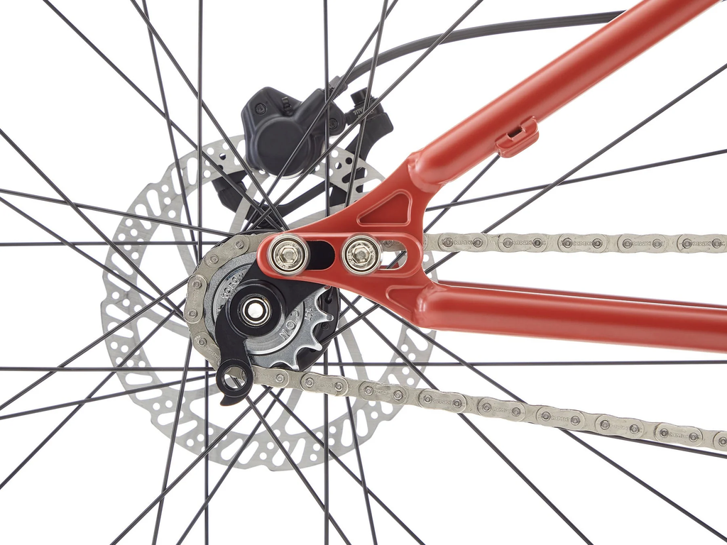 Close-up of a bicycle's gear system with red frame