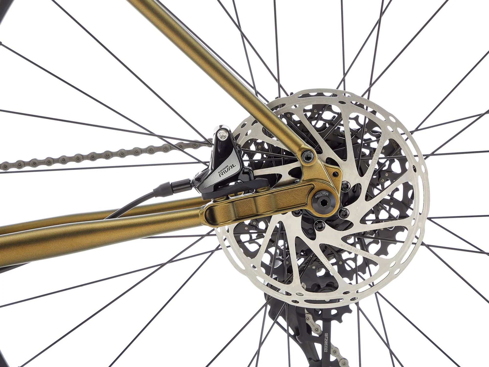 Close-up of a bicycle's gear system with gold chain and black components on a white background