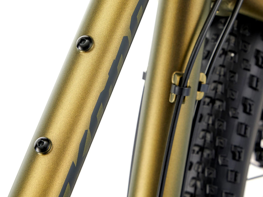 Close-up of a gold bicycle frame with a black tire on a white background