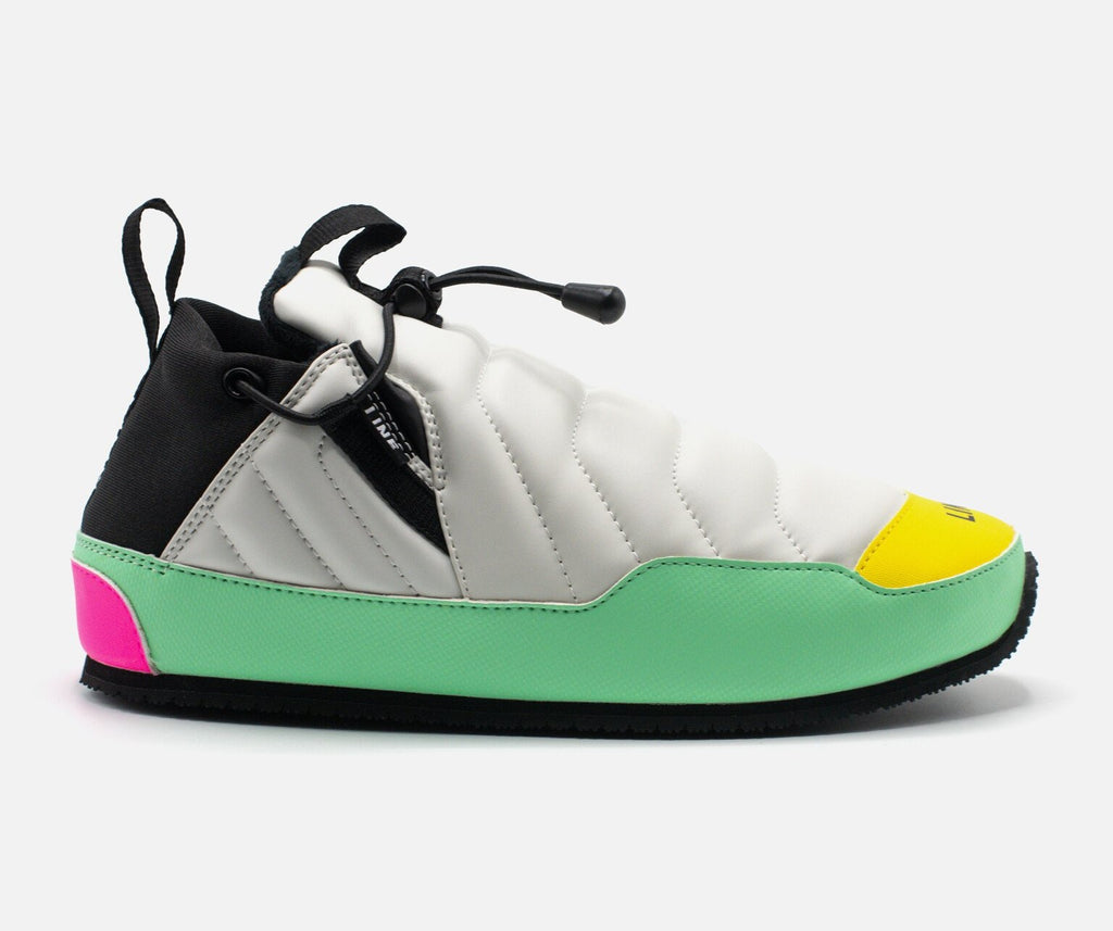 Multicolored sneaker with black, white, green, pink, and yellow accents on a light gray background