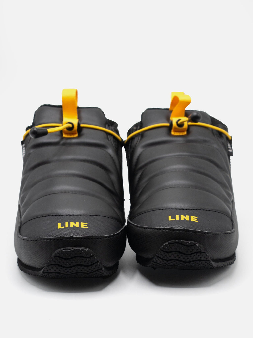 Pair of black shoes with yellow accents and 'LINE' branding on a white background