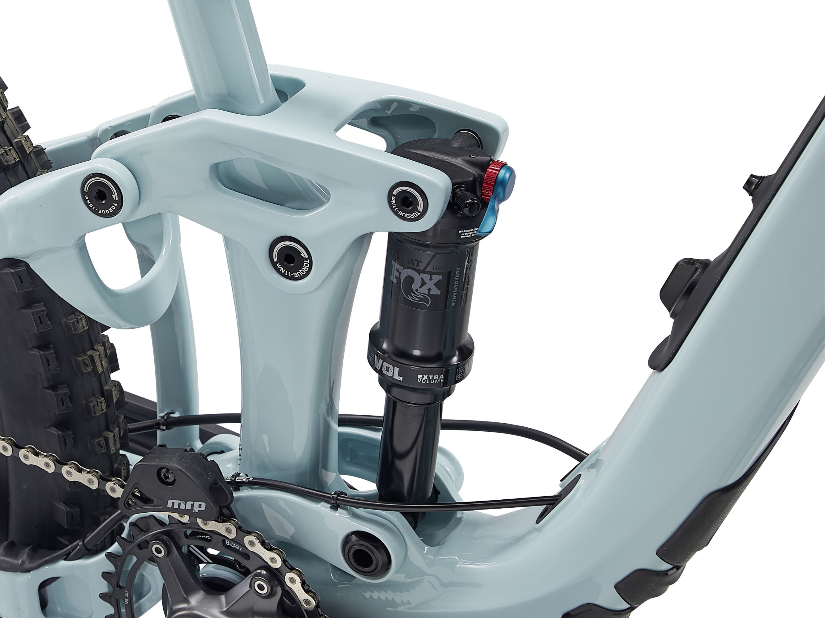 Close-up of a light blue mountain bike frame with suspension fork and chain.