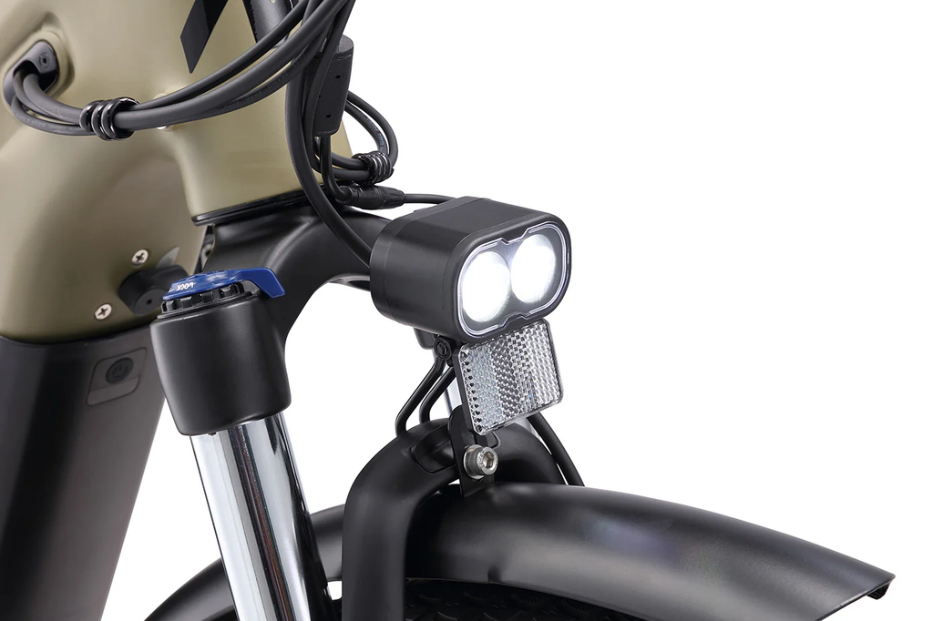 Close-up of a motorcycle headlight and handlebar on a white background