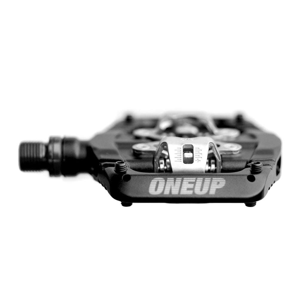 Black and silver cycling pedal with 'ONEUP' branding on a white background
